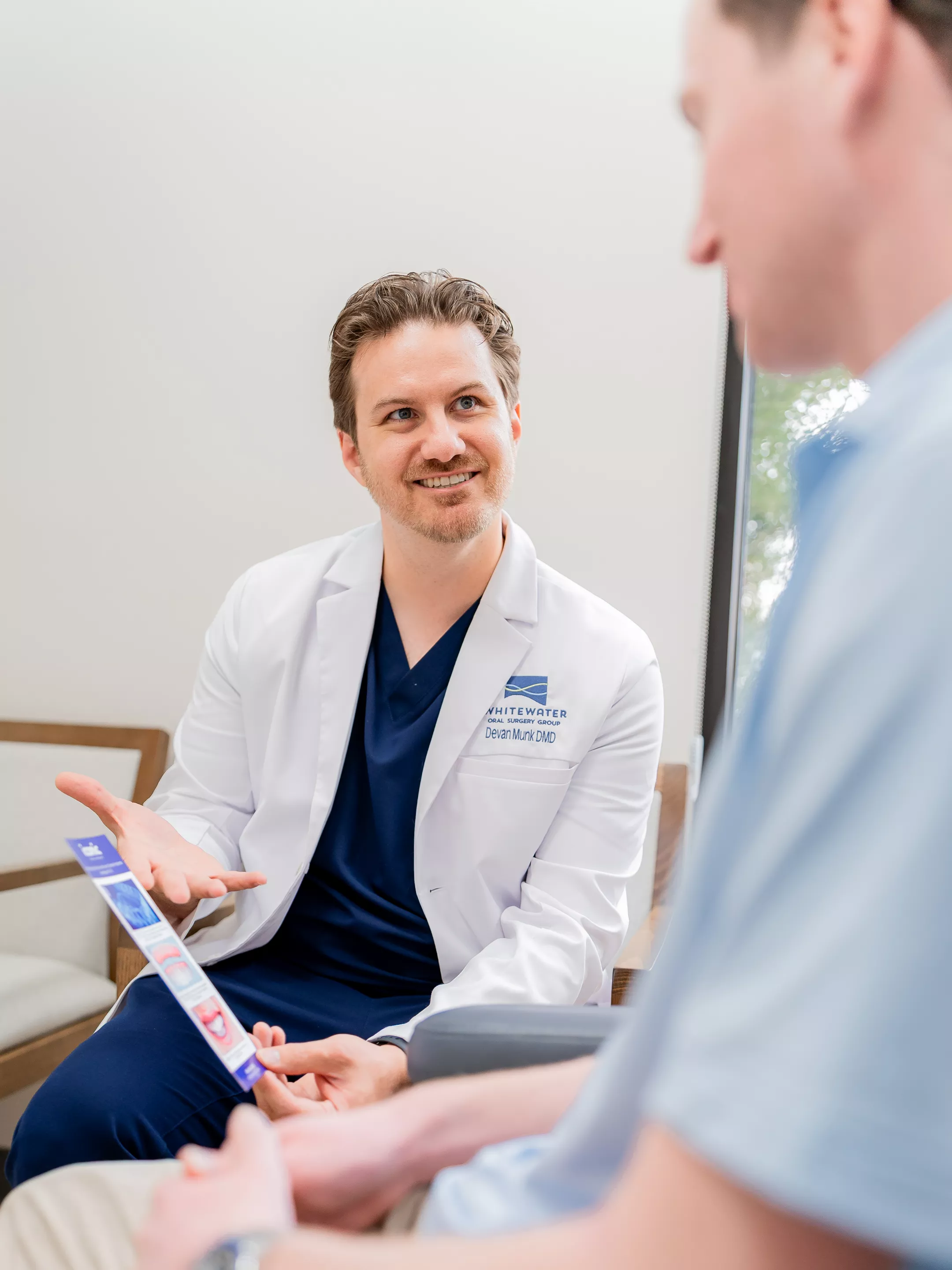 Dr. Munk consulting with a patient.